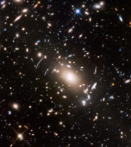 This view of a massive cluster of galaxies unveils a very cluttered-looking universe filled with galaxies near and far